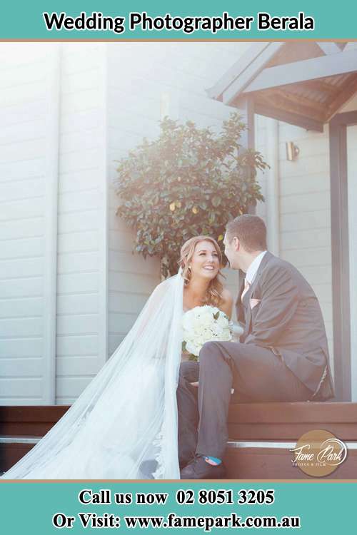 Photo of the Bride and the Groom looking each other while sitting at the staircase Berala NSW 2142