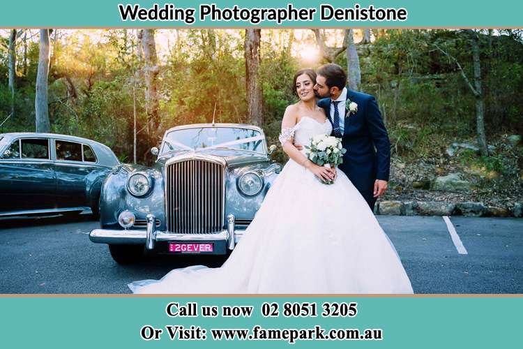 Photo of the Bride and the Groom at the front of the bridal car Denistone NSW 2114