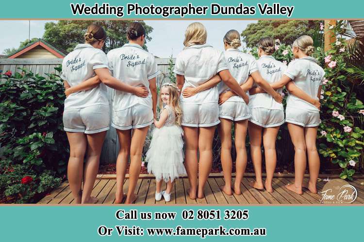 Behind photo of the Bride and the bridesmaids with the flower girl looking back Dundas Valley NSW 2117