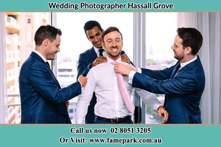 Photo of the Groom helping by the groomsmen getting ready Hassall Grove NSW 2761