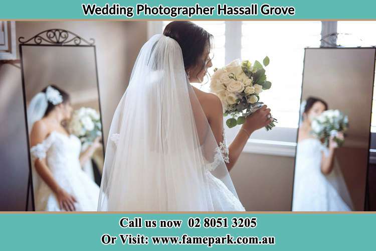 Photo of the Bride holding flower at the front of the mirrors Hassall Grove NSW 2761